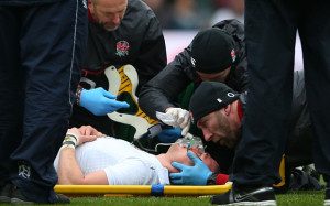 Mike Brown is treated on the pitch during England's Six Nations match against Italy