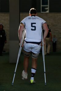 Greg Peterson leaves the field on crutches (Courtesy - Lachlan Cunningham/Getty Images North America) 