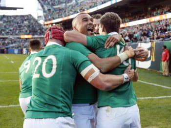Ireland's Simon Zebo, center, celebrates with Johnny Sexton, right, and Josh van der Flier, left, after scoring against New Zealand during the second half of a rugby match Saturday, Nov. 5, 2016, in Chicago. (AP Photo/Kamil Krzaczynski)