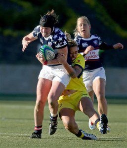 In this Feb. 15, 2014 file photo, United States' Jillion Potter, foreground, is tackled by Australia's Hanna Sio in a Women's Sevens World Series rugby game at Kennesaw State University in Kennesaw, Ga. (AP Photo/Jason Getz, File)