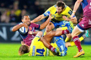 Bordeaux-Begles’ Darly Domvo, left, is tackled in the match against Clermont